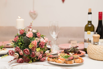 Festive table with snacks and flowers