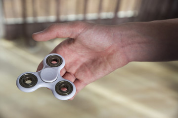 Boy playing with fidget spinner toy