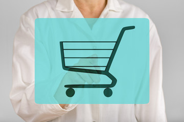 Person pointing with finger on shopping cart