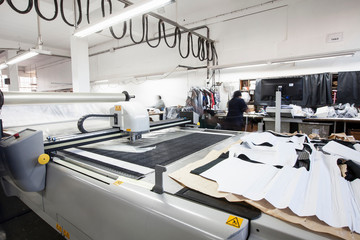 Pattern cutting machine cutting out textiles in clothing factory
