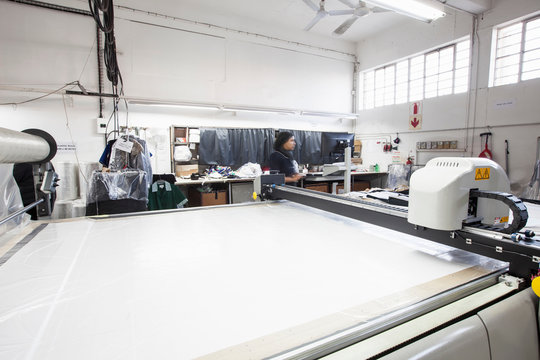 Pattern cutting machine and factory worker in clothing factory