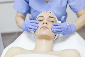Naklejka premium Cosmetic treatments for the skin in the beauty salon. Woman in spa salon