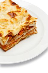 Portion of tasty lasagna isolated on white