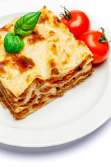 Portion of tasty lasagna isolated on white