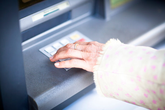 Hand of woman pressing keyboard at local french cash machine