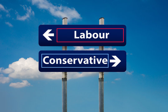 two road signs representing labour and conservative parties in uk early elections in june