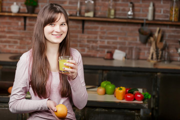 Obraz premium Portrait of a pretty woman holding glass with tasty juice