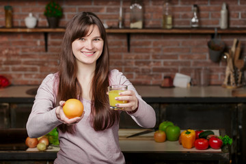 Portrait of a pretty woman holding glass with tasty juice