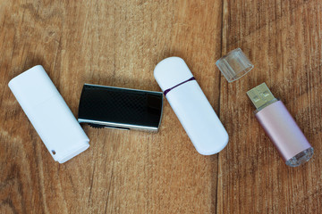 Set of flash drives on a wooden table.