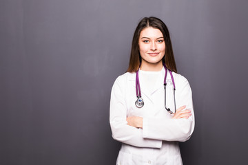Portrait of young medical doctor on a grey background