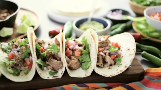 Pulled pork carnitas with pico de gallo on a flour tortilla