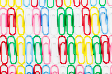 Row of colorful paper clips on white background