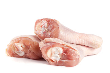 Three raw chicken drumsticks isolated on white background