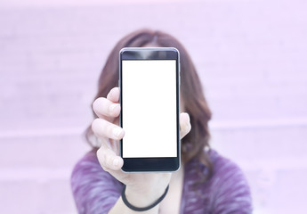 Woman holding modern smartphone. Horizontal mockup. Replaceable with own design. Portrait mode,...