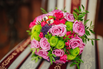 Wedding. Wedding bouquet and selective focusing rings Bouquet and accessories of bride and groom. Wedding closeup details