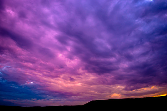 Photo of a violet sunset with clouds