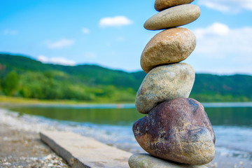 Photo of stones balanced on top of eachother on a beach