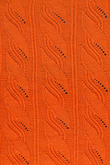 texture of an orange knitted openwork pattern closeup