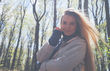 Young woman enjoying nature during sunny day in spring park