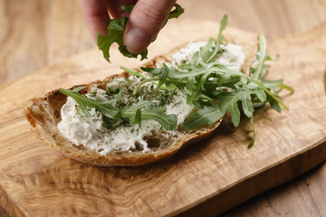 arugula on rustic bread with ricotta cheese, shallow focus