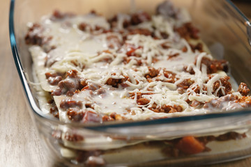 preparing lasagna process on home kitchen for family dinner, shallow focus