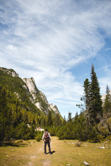 Fototapeta na wymiar Man trekking / hiking in alpine scenery and nice weather.