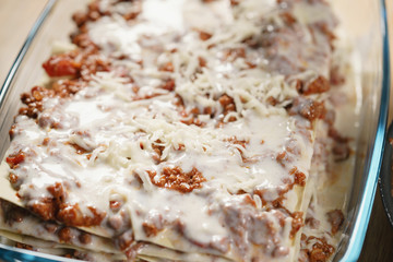 preparing lasagna process on home kitchen for family dinner, shallow focus