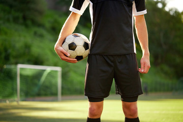 soccer player with ball on football field