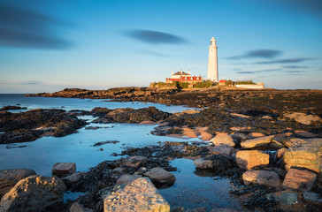 Obraz premium Long Exposure at St Mary's Island / St Mary's Lighthouse on a small rocky Island, just north of Whitley Bay on the North East coast of England. A causeway submerged at high tide links to the mainland