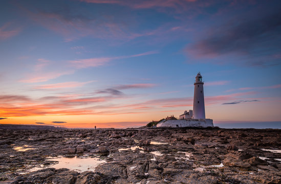 Dusk at St Mary's Lighthouse / St Mary's Lighthouse on a small rocky Island, just north of Whitley Bay on the North East coast of England. A causeway submerged at high tide links to the mainland