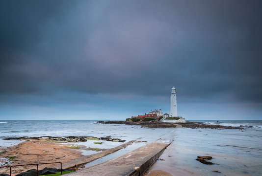 Causeway to St Mary's Lighthouse / St Mary's Lighthouse on a small rocky Island, just north of Whitley Bay on the North East coast of England. A causeway submerged at high tide links to the mainland