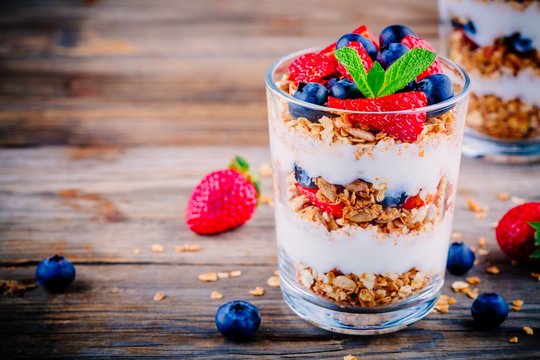 Yogurt parfait with granola,  strawberries and blueberries