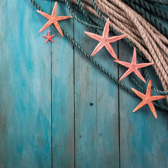Summer time sea vacation background with star fish, marine rope on dark blue background