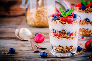 Yogurt parfait with granola,  strawberries and blueberries