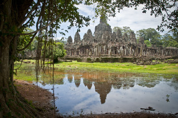 Fototapeta na wymiar Reflections in the water of a temple in Angkor