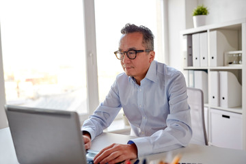 businessman in eyeglasses with laptop office