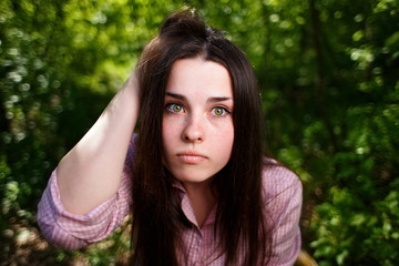 Naklejka premium Portrait of attractive young pensive perplexed woman face close up