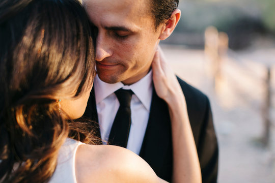 Mid adult couple outdoors, in romantic embrace