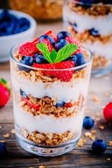 Yogurt parfait with granola,  strawberries and blueberries