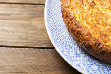Close-up of omelette on wooden table. Typical Spanish omelette