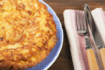 Omelette served with fork and knife on napkin. Horizontal shoot.