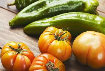 Close-up of Tomatoes and peppers on wooden table. Horizontal shoot. Healthy food.