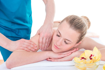 Obraz na płótnie Canvas Professional masseur massaging female shoulder and arms. Relaxing spa procedures. Pleasure, rest, body care, beauty, alternative medicine concept