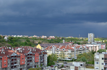 Fototapeta premium Dark blue stormy sky above a quarter of residential tall buildings in New Belgrade, Serbia