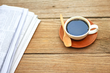 Stock Photo - The newspaper with cup of coffee on rustic wooden background
