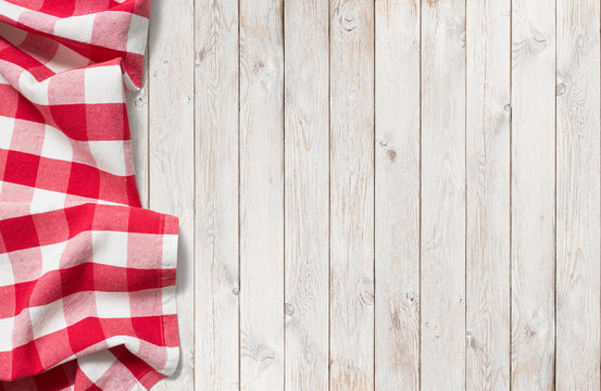 red picnic cloth on white wood table