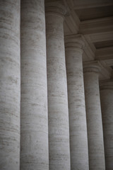 A row of columns near an ancient architectural structure