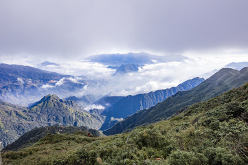 Valley covered with clouds. View from Fansipan - the highest mountain in Indochina located in Sapa, Hoang Lien Son mountain range, Lao Cai Province, Vietnam
