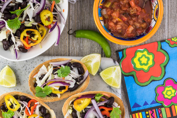 Mini taco boats with black beans and vegetables.