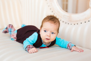 Portrait of adorable baby boy lying on tummy
